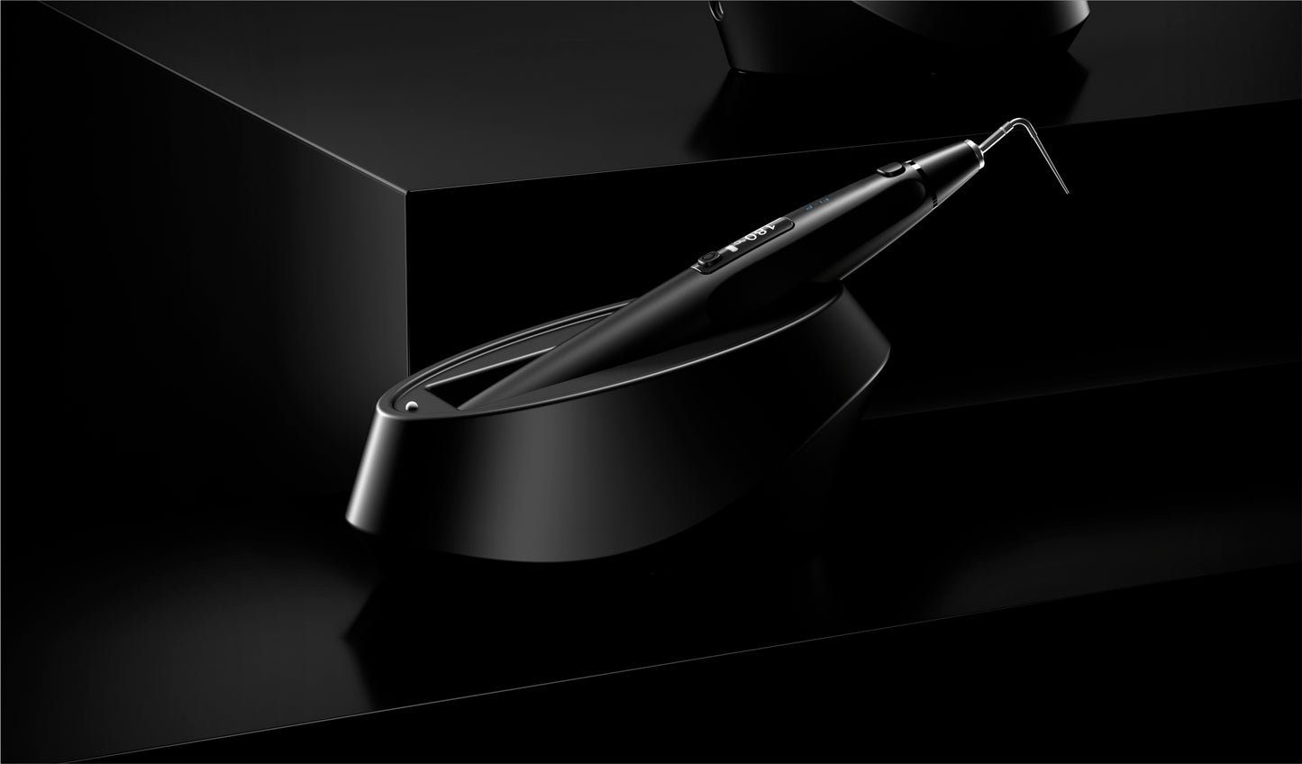 Woodpecker Fi-P wireless gutta-percha obturation device resting on its charging dock. Designed for efficient root canal filling with ergonomic handling and temperature control.