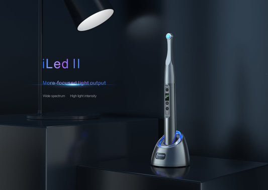Woodpecker iLED II wireless dental curing light on its charging base, featuring high-intensity LED output, wide-spectrum coverage, and rapid polymerization for efficient dental restorations. This professional curing device ensures deep, uniform curing with optimized light focus, enhancing durability and precision in dental treatments. Modern, ergonomic design for seamless operation in clinics.